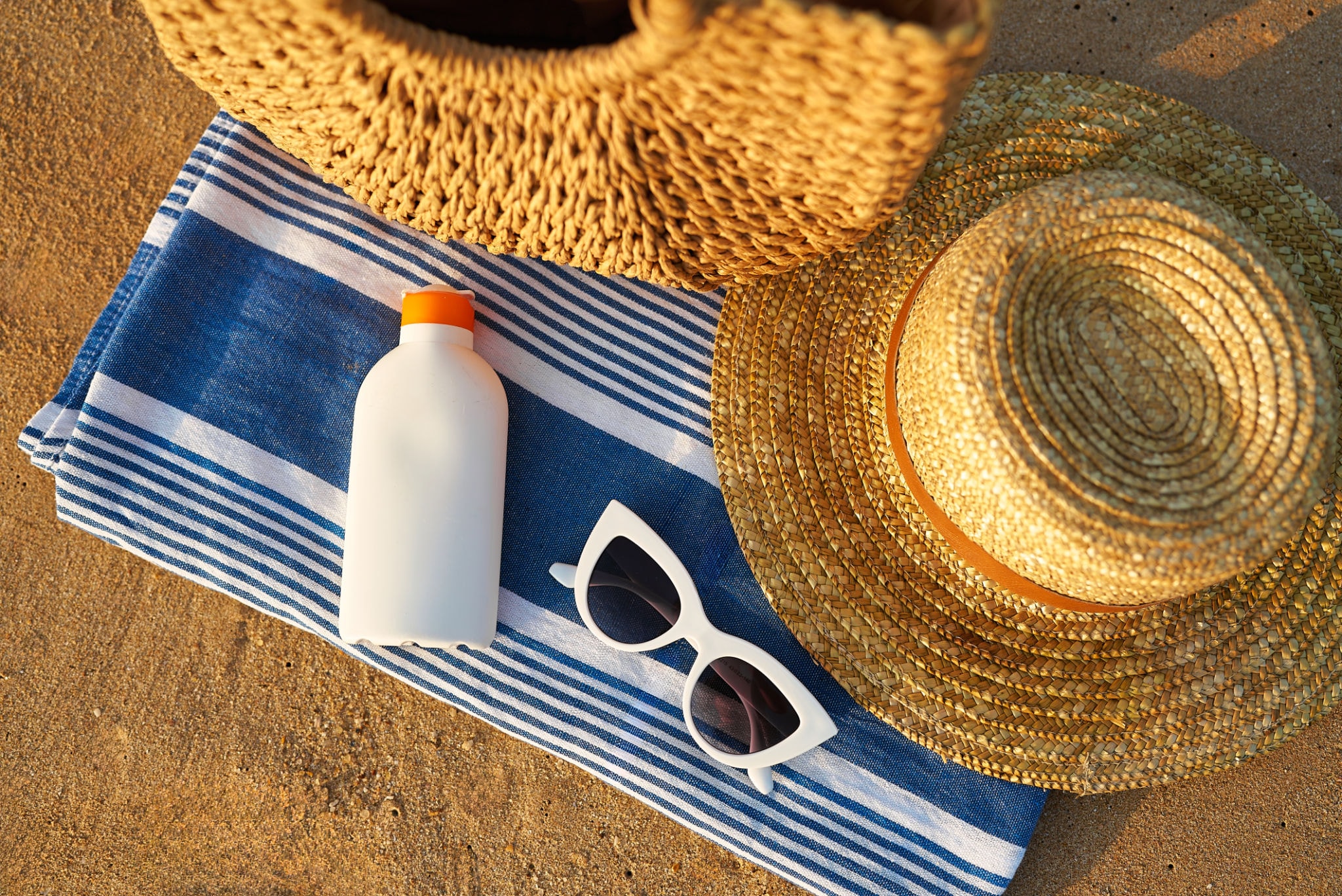 Sun and swim essentials — sunscreen, sunglasses, beach gear at WakeZone General Store